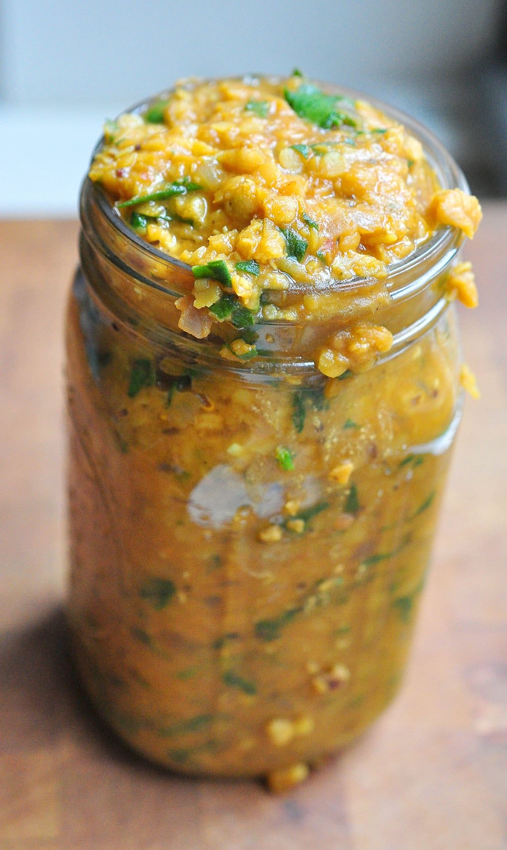 jar full of curried red lentil and spinach stew