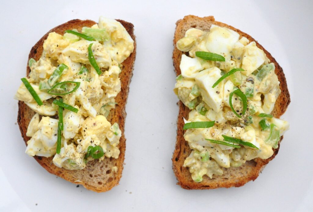 green chile egg salad topped on 2 pieces of toast