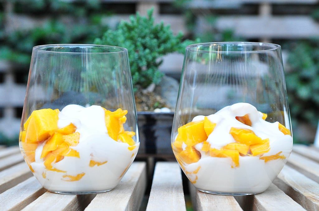 2 cups piled with chopped mango and coconut cream