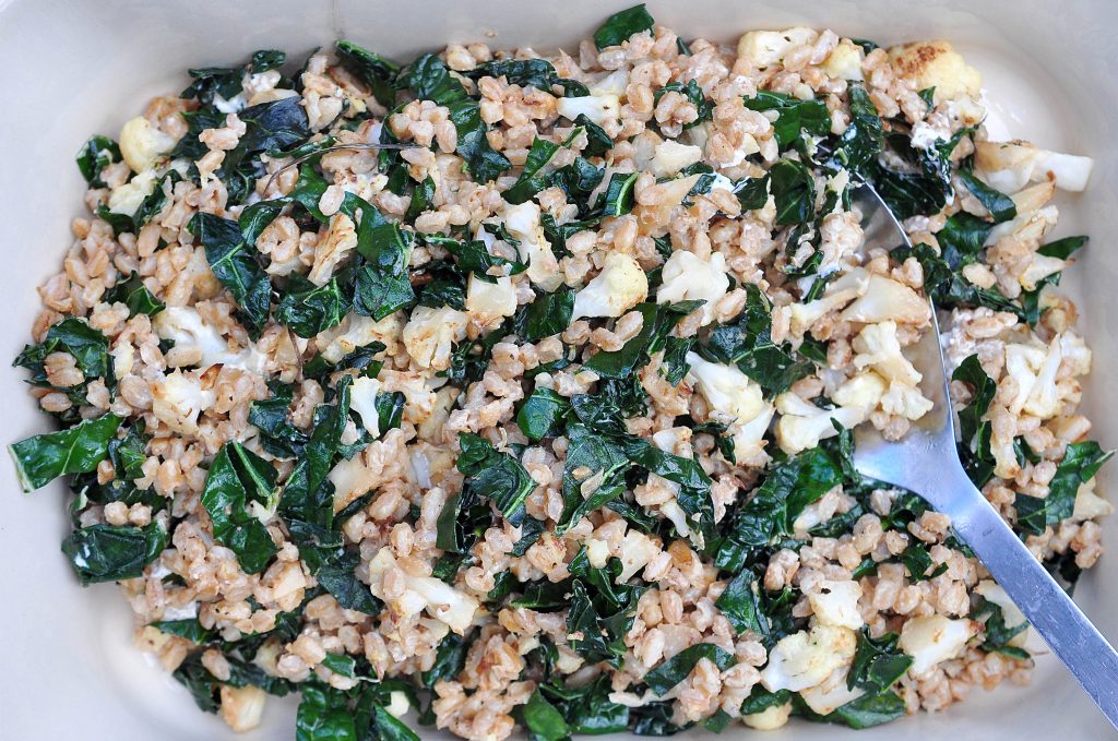 a large pan of farro, cauliflower and kale salad