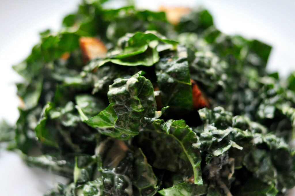 plate of kale caesar salad with croutons