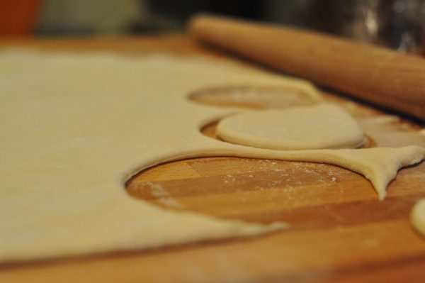 perogy dough rolled out with pieces cut out
