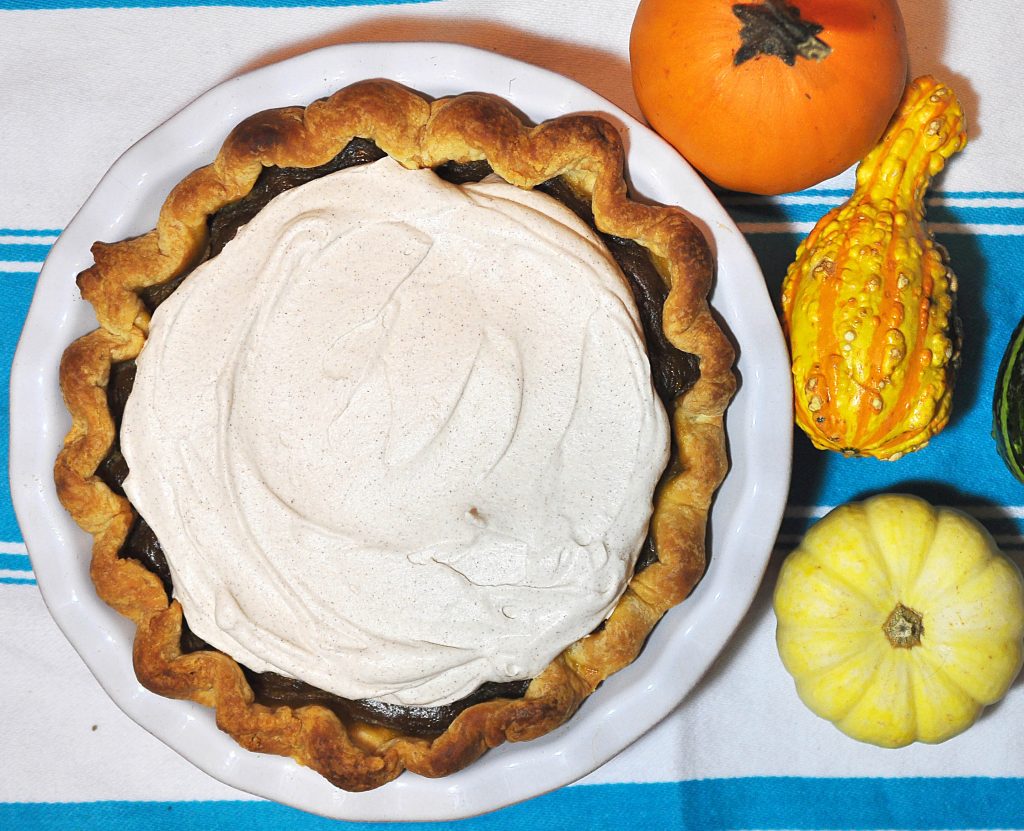 Pumpkin pie with a side of decorative gourds