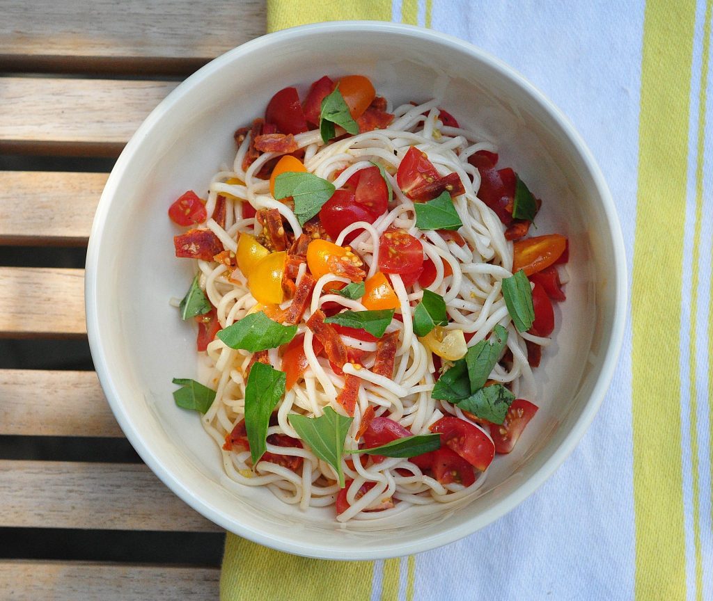 noodles tossed with tomato, basil and salami