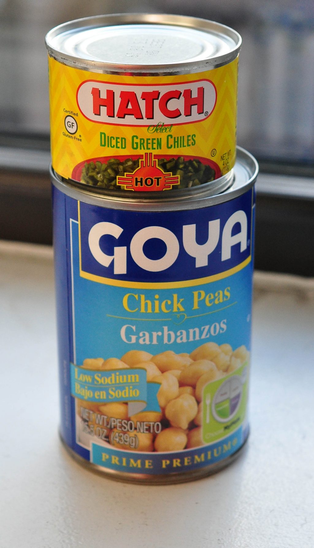 can of chickpeas and can of green chiles on top