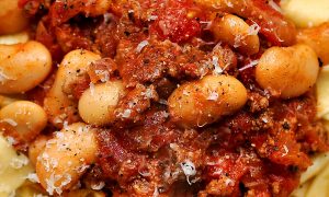 Chorizo and white bean ragu on a bed of fresh pasta