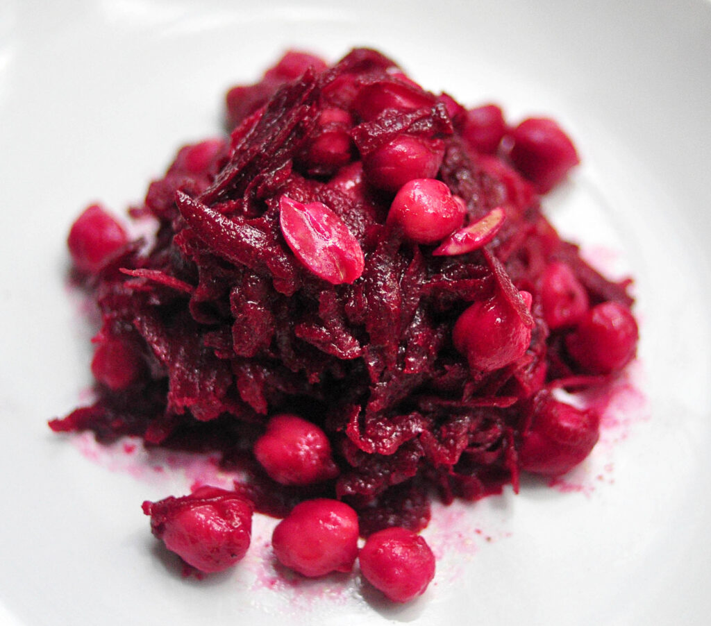 beet and chickpea salad piled on a white plate