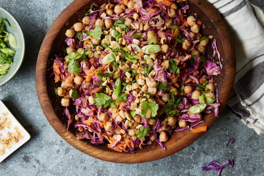 wooden bowl filled with chickpea and vegetables salad