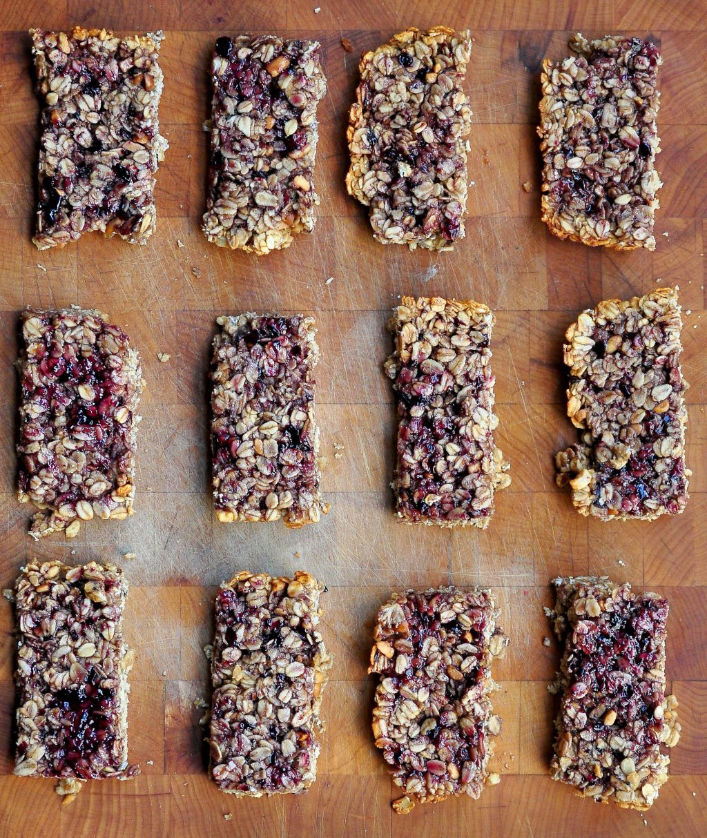 peanut butter and jelly granola bars on laying on a wooden board