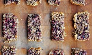 peanut butter and jelly granola bars on laying on a wooden board