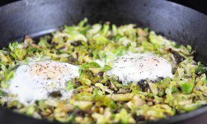 cast iron pan with brussels sprouts hash and eggs