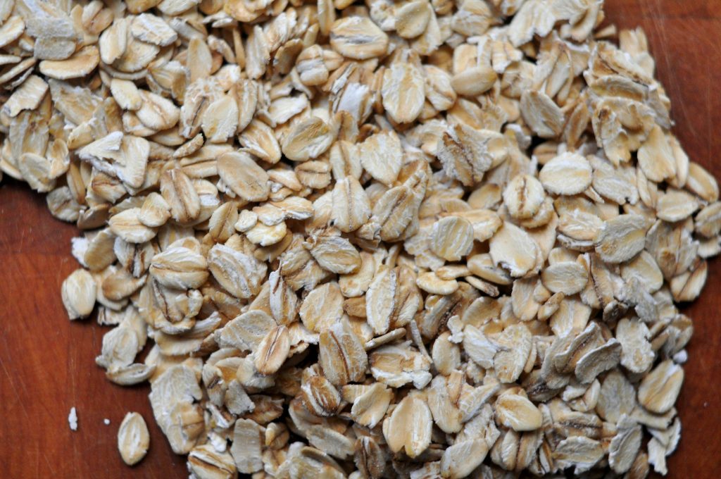 oats spread on a wooden background